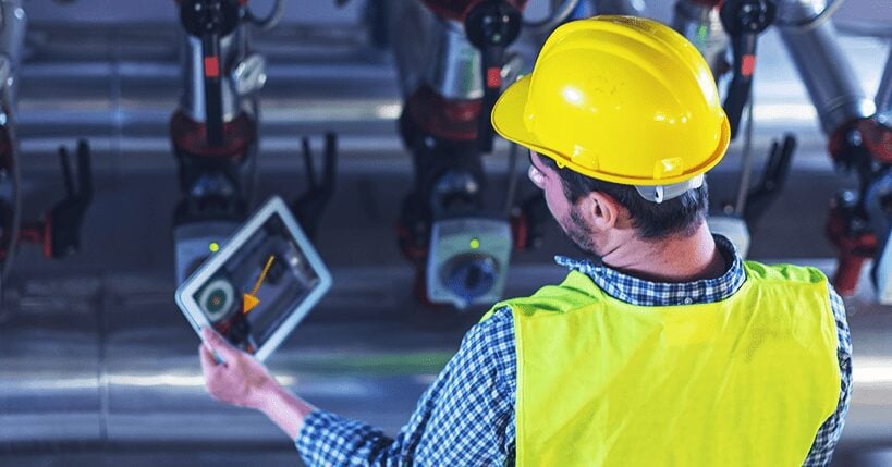 worker with a tablet in a hard hat