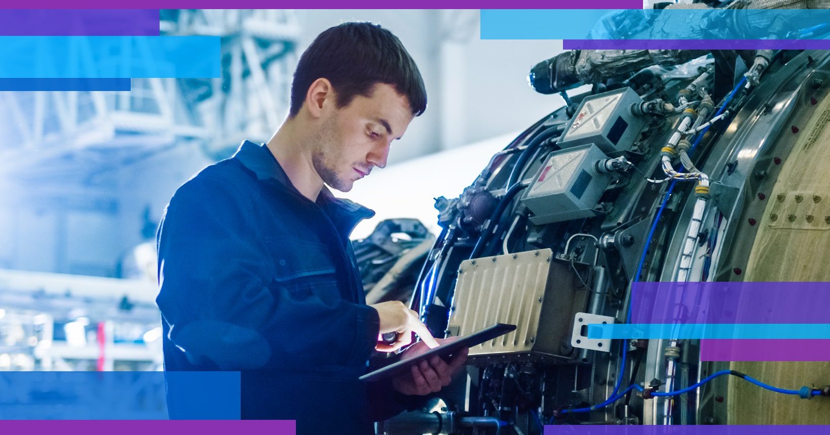 A field technician holding a tablet in front of machinery