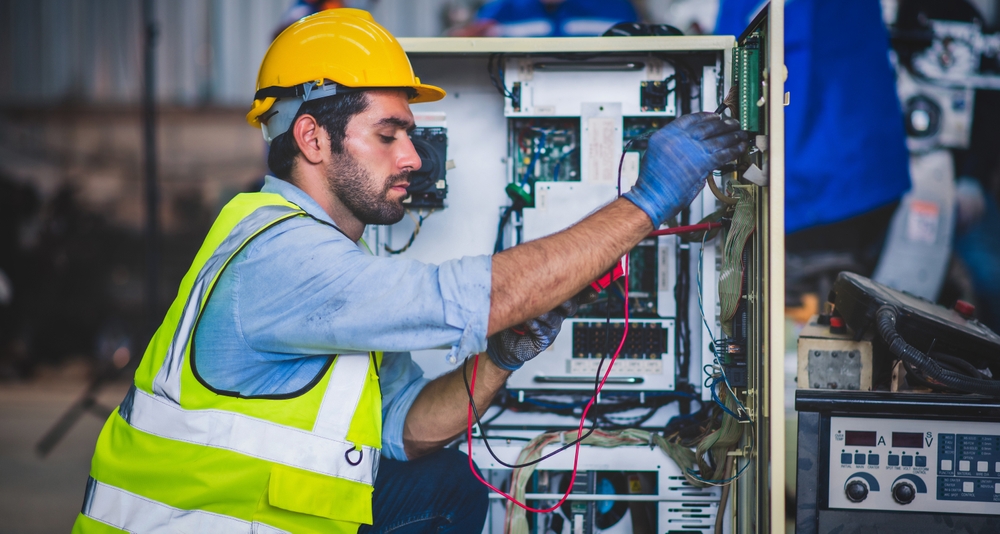 A field service technician inspecting electric box