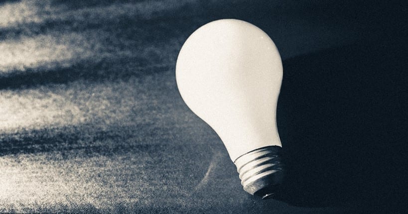 White lightbulb on a black background