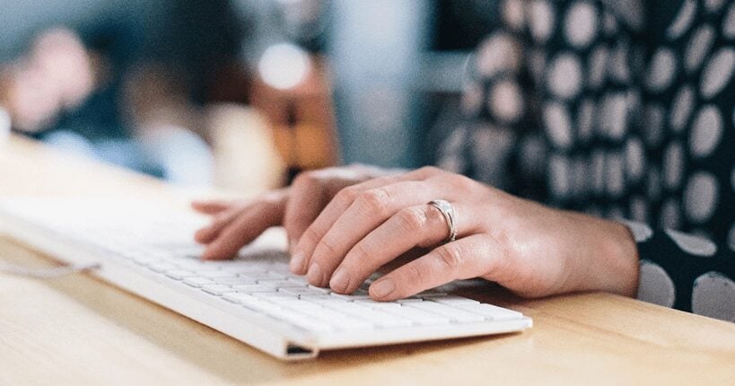 woman typing on a keyboard