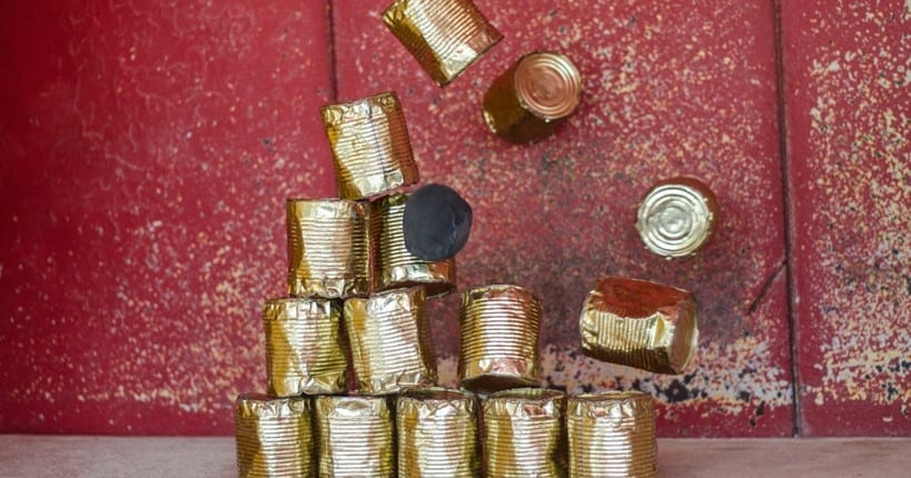 crumbling pyramid from gold-colored metal tins