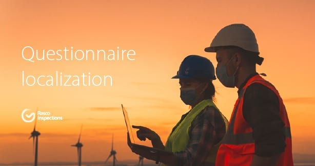 two people in hard hats and wind turbines