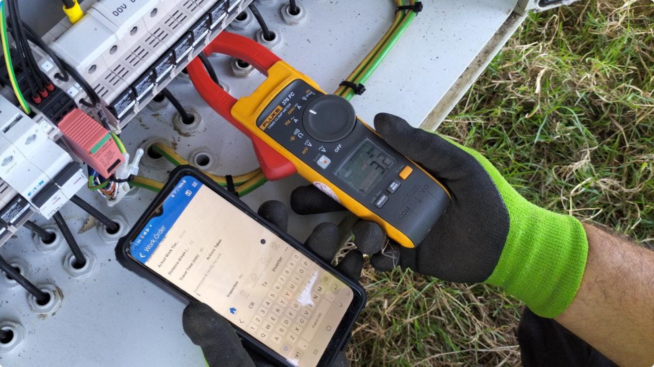 Worker inspecting electric fuses with Mobile CRM app